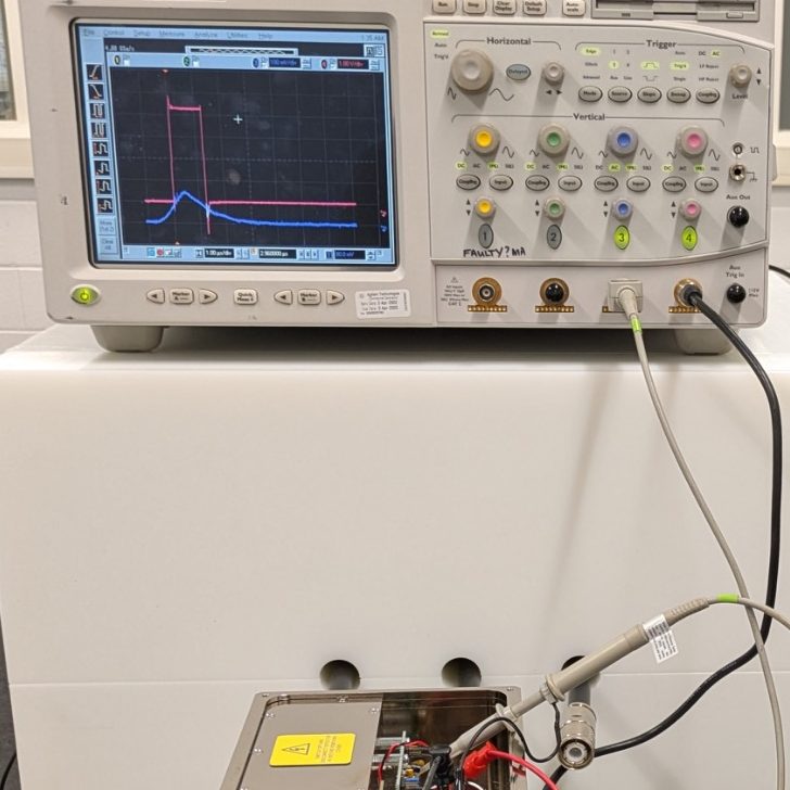 Measuring the output from a pair of helium-3 proportional counters (purple trace) input into a preamplifier/discriminator and associated output pulse (magenta trace). Oscilloscope and probe tracing preamplifier/discriminator input/output.