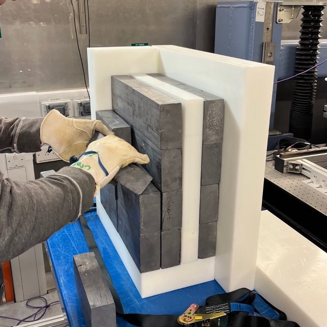 Subassembly test rig being assembled in the STFC ChipIr Facility to evaluate the thermal neutron flux in the neutron detector void. Polyethylene blocks and lead bricks being assembled.